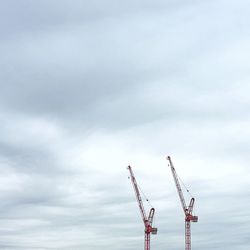 Low angle view of crane against sky