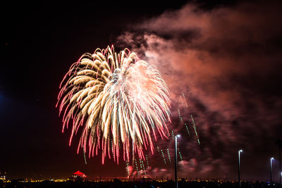 Low angle view of firework display at night