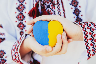 Midsection of woman holding globe