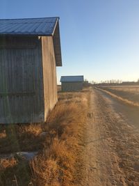 House on field against clear sky