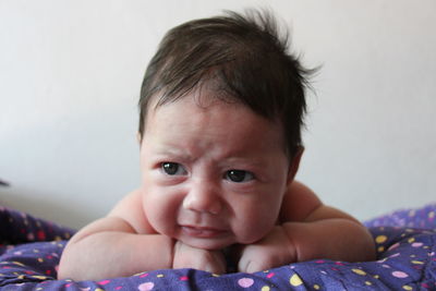 Close-up of cute baby boy crying at home