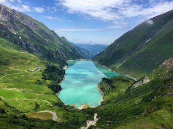 Scenic view of valley and mountains against sky