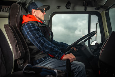 Rear view of man driving car