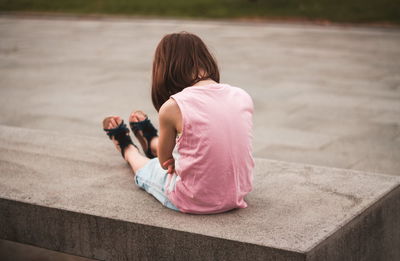 Little girl sitting alone on the bench