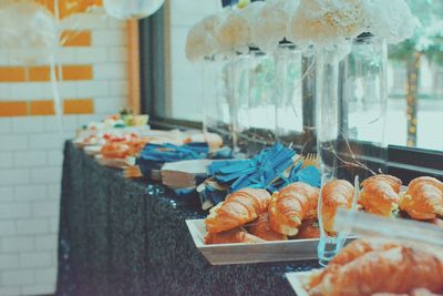 Croissants and kitchen utensils on table in restaurant