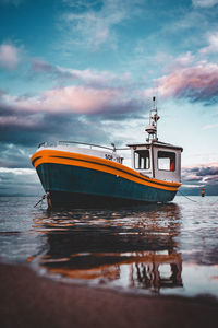 Boat sailing on sea against sky