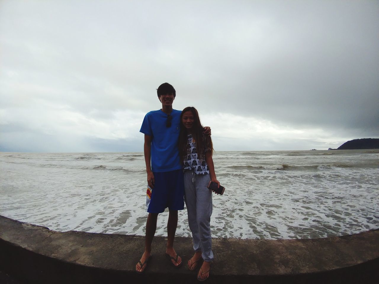 two people, cloud - sky, beach, outdoors, sky, men, sea, standing, full length, leisure activity, sand, males, people, only men, adults only, young adult, adult, real people, vacations, togetherness, nature, day, sand dune