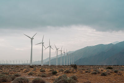 Wind turbines against sky