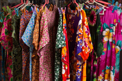 Close-up of clothes hanging in store for sale