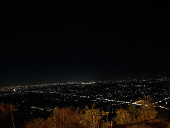 High angle view of illuminated buildings against sky at night