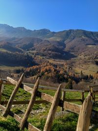 Scenic view of field and mountains against sky