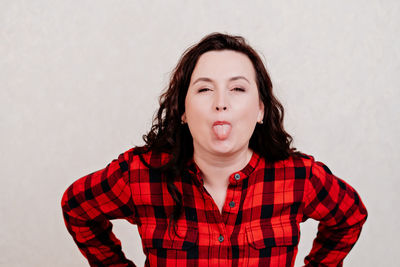 Portrait of beautiful young woman against white background