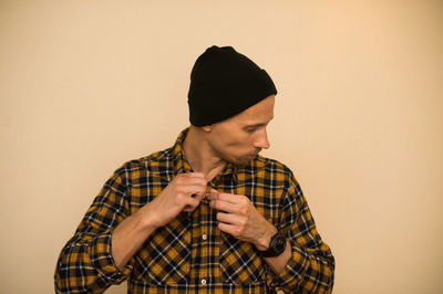 Young man looking away against white background