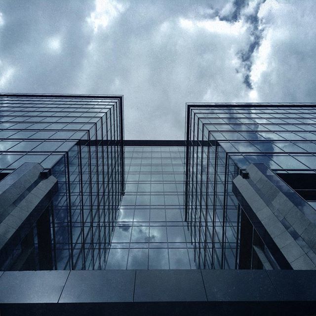 sky, architecture, building exterior, built structure, cloud - sky, low angle view, cloudy, modern, cloud, glass - material, office building, building, city, window, overcast, weather, day, reflection, outdoors, no people