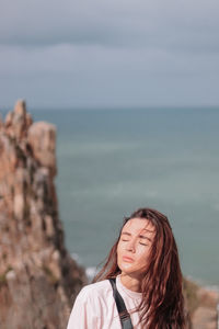 Portrait of woman against sea