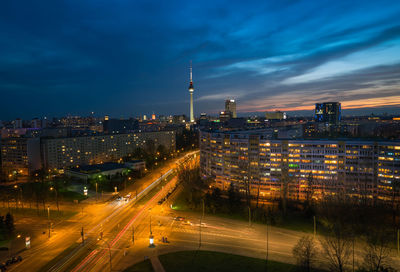 High angle view of illuminated street amidst buildings at night