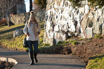Full length of a woman walking on road