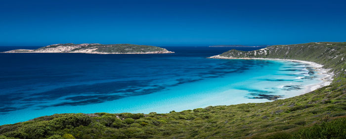 Scenic view of sea against clear blue sky