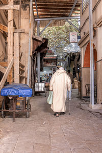 Rear view of man standing in abandoned building