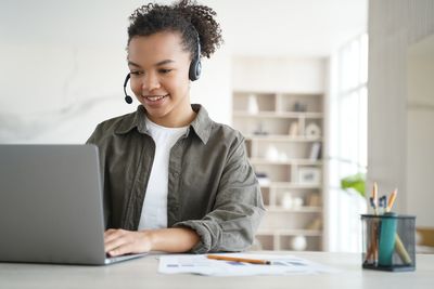 Businesswoman using laptop at office