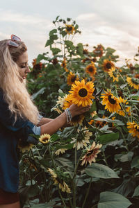 Low angle view of woman against cloudy sky