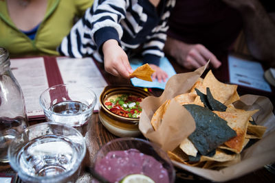 Toddler with parents having food at table