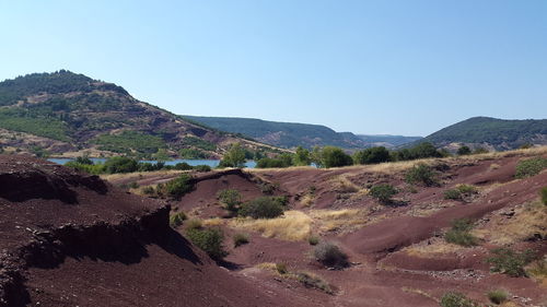 Scenic view of landscape and mountains against clear blue sky