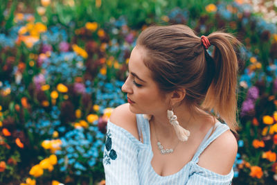 Close-up of woman with red flower