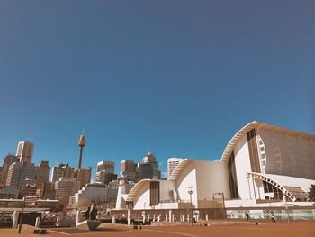 View of cityscape against clear blue sky