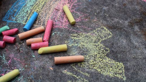 High angle view of colorful chalks on road