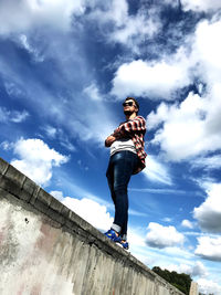 Low angle view of man standing against sky