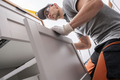 Low section of man working in car