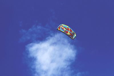 Low angle view of flag against blue sky