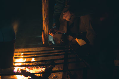 People enjoying on wooden structure against sky at night