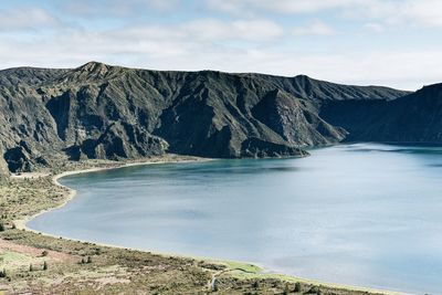 Scenic view of sea and mountains against sky