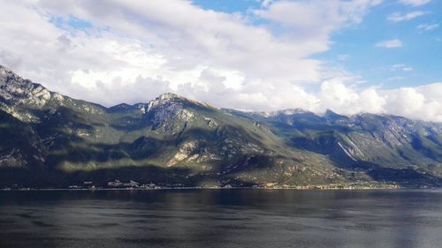 Scenic view of lake against cloudy sky