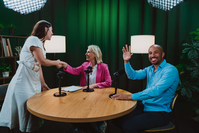 Portrait of businessman and client sitting on table