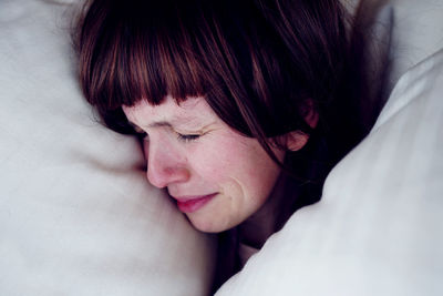 Close-up of sad woman on bed