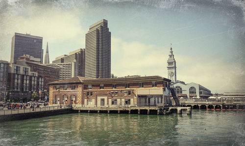 Bridge over river with buildings in background