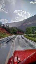 Empty road with trees in background