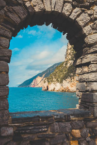 Scenic view of sea seen through arch