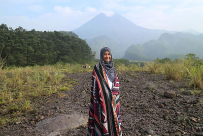Portrait of woman with scarf standing on land