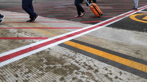 Low section of people walking on road