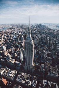 High angle view of empire state building amidst city against sky