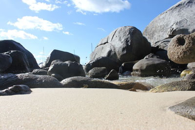 Rocks on beach against sky