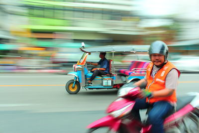 Blurred motion of man riding motorcycle