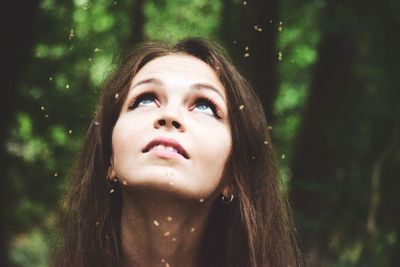 Close-up portrait of a teenage girl in forest