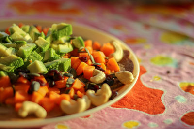 A special salad with avocado, cucumbers, and cashews is prepared to eat healthy and refreshing - b.s