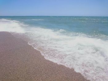 Scenic view of beach against blue sky