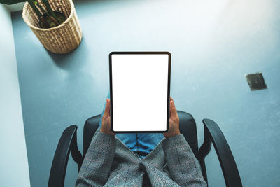 High angle view of woman using mobile phone on table